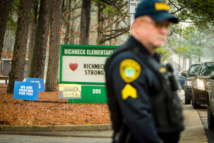 A police officer directs traffic at Richneck Elementary School in Newport News, Virginia, after a 6-year-old boy shot his teacher.
