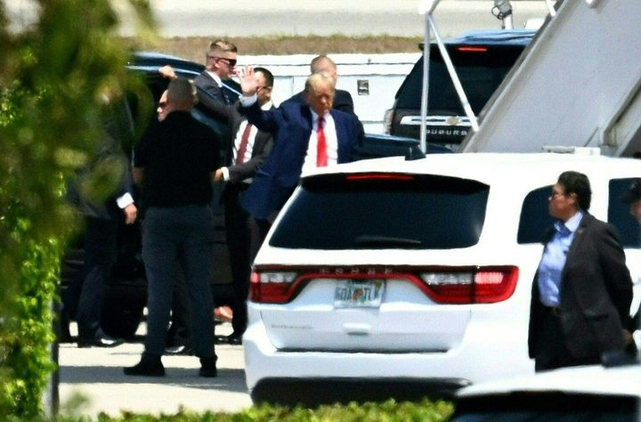 Former US president Donald Trump waves as he boards his plane at Palm Beach International Airport in West Palm Beach, Florida.