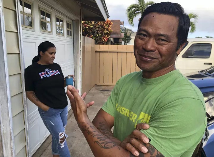 Tedorian Gallano, right, and his wife Nicole Gallano, stand outside their home in Waianae, Hawaii, on Feb. 26.