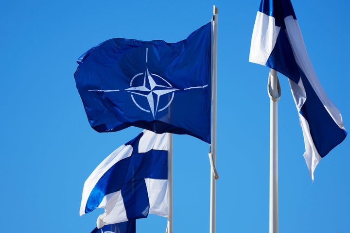 NATO flag, centre, and Finland flags flutter over the building of Ministry of Foreign Affairs in Helsinki, Finland, Tuesday, April 4, 2023. Finland prepared to make its historic entry into NATO Tuesday, a step that doubles the Western alliance’s border with Russia and ends decades of non-alignment for the Nordic nation. (AP Photo/Sergei Grits)