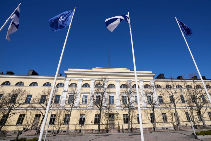 NATO and Finland flags flutter over the building of Ministry of Foreign Affairs in Helsinki, Finland, Tuesday, April 4, 2023. Finland prepared to make its historic entry into NATO Tuesday, a step that doubles the Western alliance’s border with Russia and ends decades of non-alignment for the Nordic nation. (AP Photo/Sergei Grits)