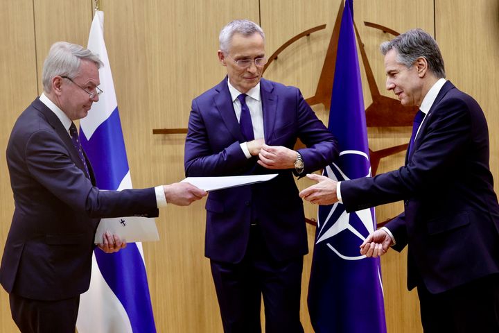 Finnish Foreign Minister Pekka Haavisto, left, hands his nation's accession document to United States Secretary of State Antony Blinken, right, during a meeting of NATO foreign ministers at NATO headquarters in Brussels, Tuesday, April 4, 2023. Finland joined the NATO military alliance on Tuesday, dealing a major blow to Russia with a historic realignment of the continent triggered by Moscow's invasion of Ukraine. (Olivier Matthys, Pool Photo via AP)
