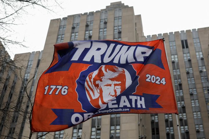 A flag in support of former US president Donald Trump is waved outside Manhattan Criminal Courthouse on the day of his planned court appearance after his indictment by a Manhattan grand jury following a probe into hush money paid to porn star Stormy Daniels, in New York city.