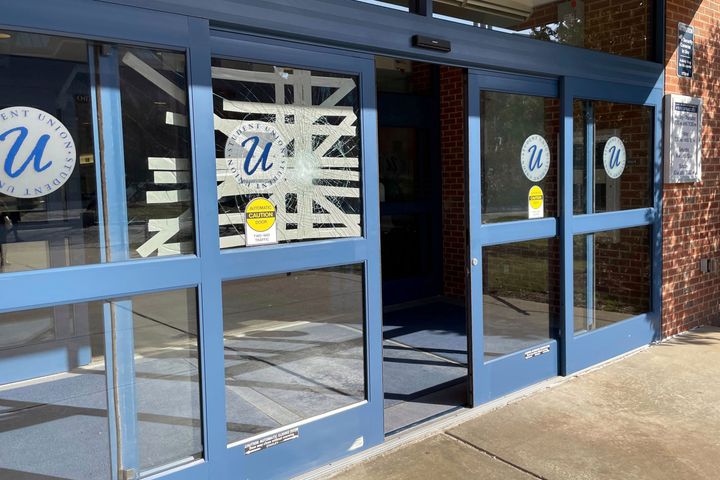 Tape covers a broken window on a door of the Student Union building on the University of Connecticut campus, in Storrs, Conn. Fans vandalized campus after the basketball team won the NCAA championship.