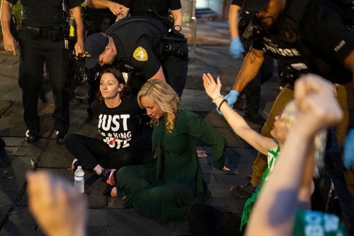State Sen. Lauren Book, seated right, along with state Democratic Party Chair Nikki Fried, seated left, and about a dozen activists who were protesting a six-week abortion ban, are arrested outside the Tallahassee City Hall building on Monday, April 3, 2023.