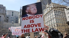 ‘Lock Him Up’: A Look At Protest Signs Outside Trump’s Arraignment