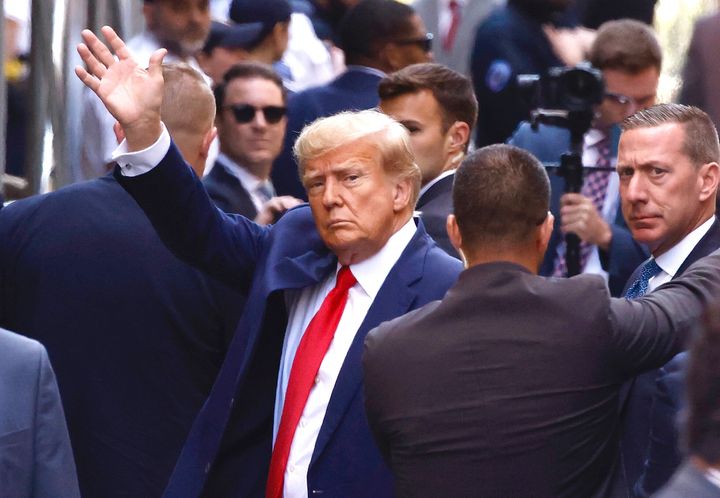 Trump waves as he arrives at the Manhattan Criminal Court.