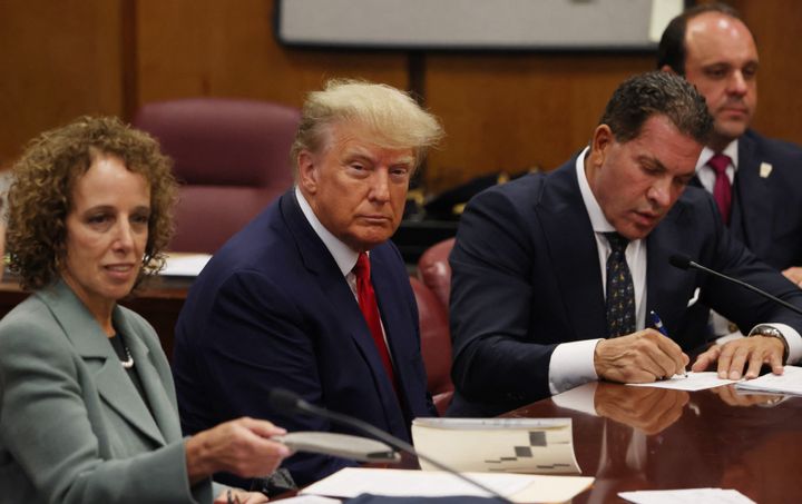 Former US president Donald Trump is accompanied by members of his legal team, Susan Necheles and Joe Tacopina, as he appears in court for an arraignment on charges stemming from his indictment by a Manhattan grand jury.