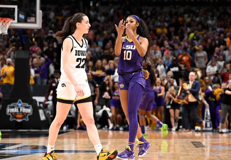 LSU Angel Reese (10) taunting Iowa Caitlin Clark (22) and pointing to her ring finger after winning the championship game vs Iowa at American Airlines Arena Dallas, Texas.