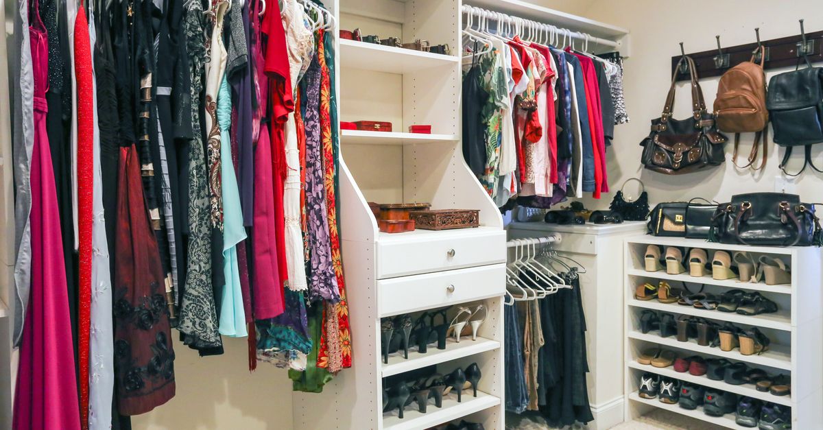 The interior of a fashion store of women's clothing of a famous brand. Mass  market. Brand clothes. All things are laid out neatly on the shelves in the  closet. Wardrobe order. Photos