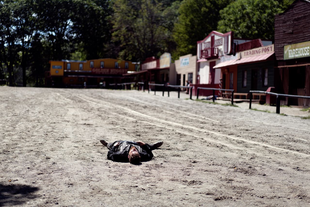 One of the Wild West City actors, lying pretend-dead on the Main Street dirt. This was the very first thing I saw once I went through the turnstiles.