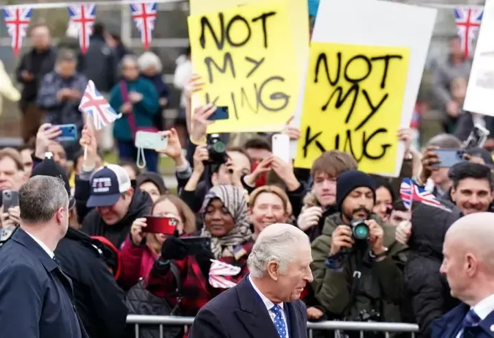 Demonstrators hold placards reading "Not My King" as King Charles meets well-wishers upon arriving at the Church of Christ the Cornerstone in Milton Keynes, England, on Feb. 16.