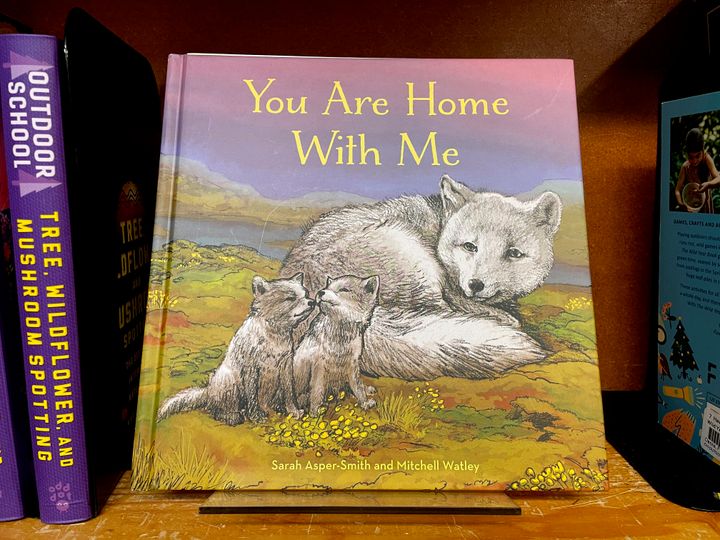 The children's book "You Are Home With Me," illustrated by Mitchell Thomas Watley, is shown at a bookstore in Portland, Ore. in this April 5, 2023, photo. Publisher Sasquatch books, owned by Penguin Random House, said it has ended its publishing relationship with Watley after he was arrested on allegations of leaving violent, transphobic notes in stores around Juneau, Alaska. 