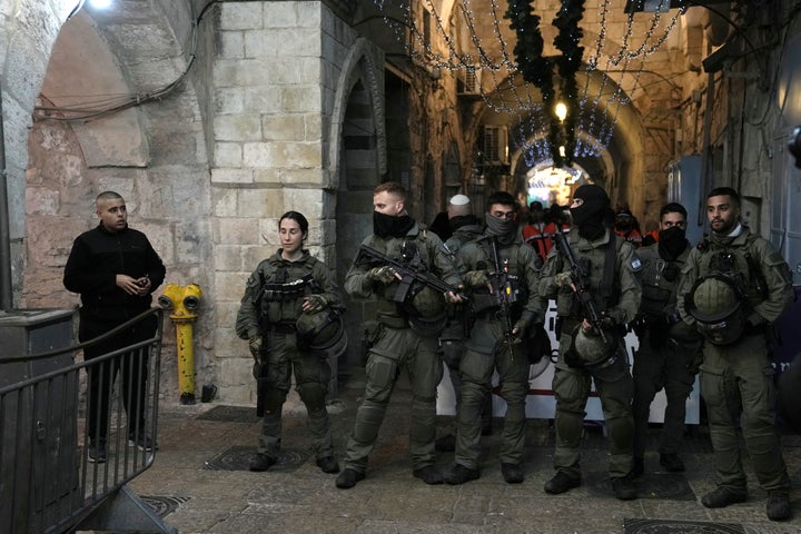 Israeli police arrest a Palestinian woman at the Al-Aqsa Mosque compound following a raid at the site in the Old City of Jerusalem during the Muslim holy month of Ramadan, on April 5, 2023.