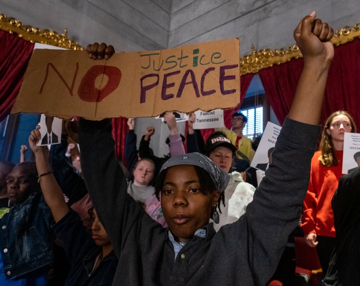 Protesters calling for gun reform laws and showing support for the three Democratic representatives who faced expulsion stand in the House gallery as legislators start Thursday's session at the Tennessee State Capitol in Nashville.