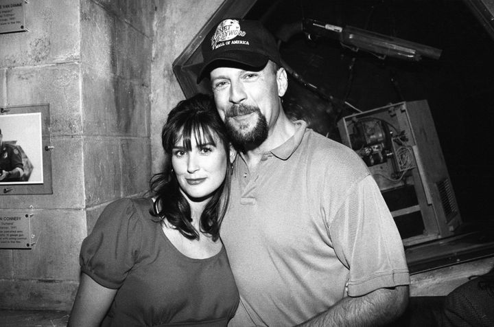 Demi Moore and Bruce Willis pose for a portrait at the opening of Planet Hollywood at the Mall of America in Bloomington, Minnesota, in 1993.