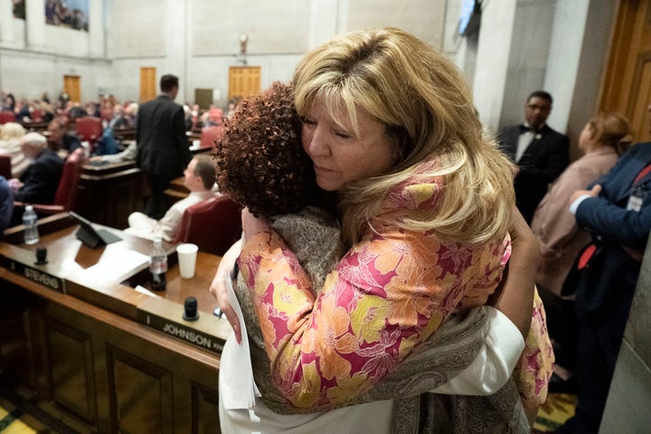 State Rep. Gloria Johnson (D-Knoxville), right, gets a hug from Rep. Karen Camper (D-Memphis) on the floor of the House after a resolution to expel Johnson from the legislature failed Monday in Nashville. Tennessee Republicans were seeking to oust three House Democrats, including Johnson, to use the bullhorn to shout support for gun control advocates in the House chamber.