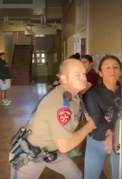 A Texas DPS trooper is seen forcibly removing Ana Rodriguez from a school when she went to pick up her son for a gun control protest.
