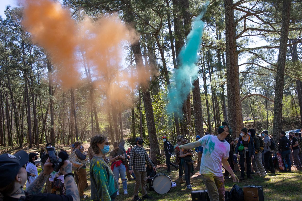 Environmental activists hold a rally and a march through the forest, March 4, in Atlanta.