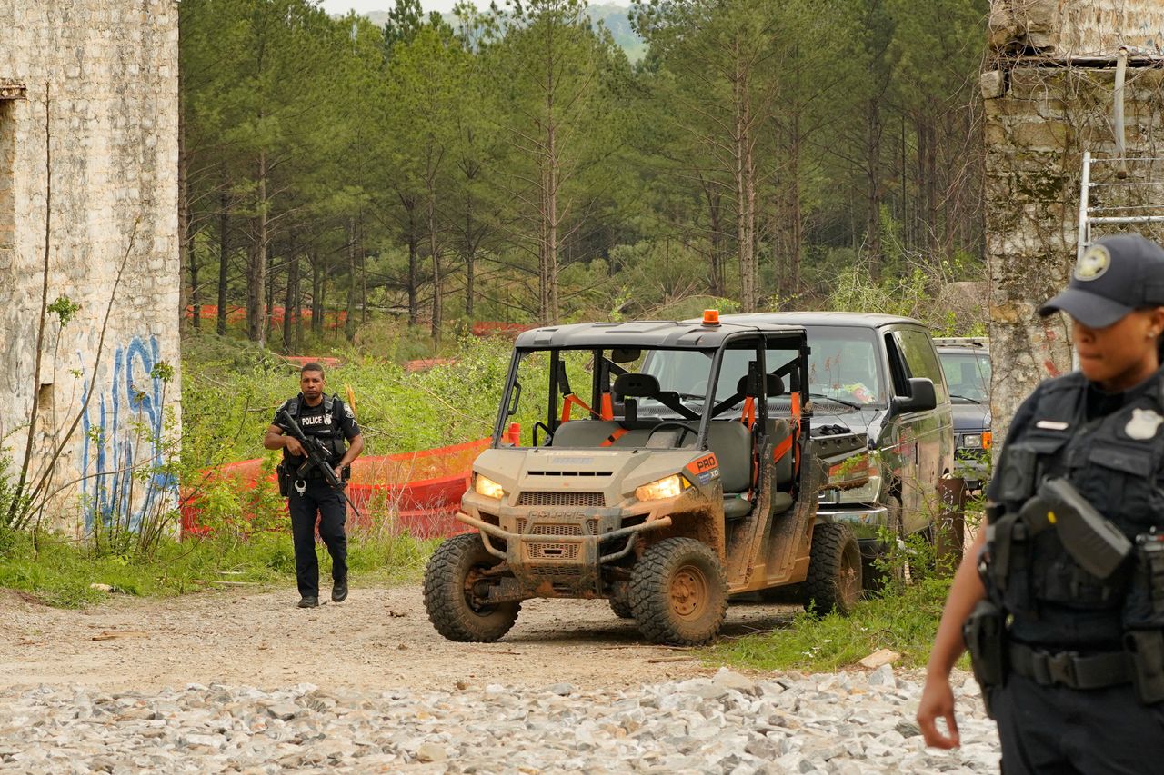 Law enforcement officers guard the entrance of the planned site of the controversial Cop City project as the clear cutting of trees begins near Atlanta, March 31.