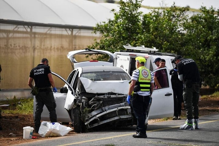 Israeli medics and policemen check a damaged car at the scene of a shooting attack, in the Jordan Valley in the Israeli-occupied West Bank April 7, 2023. REUTERS/Gil Eliyahu