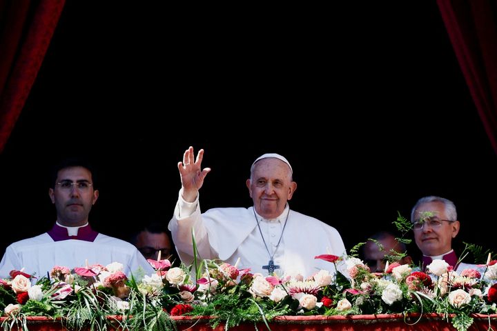 Pope Francis waves from a balcony at St. Peter's Square on Easter Sunday.