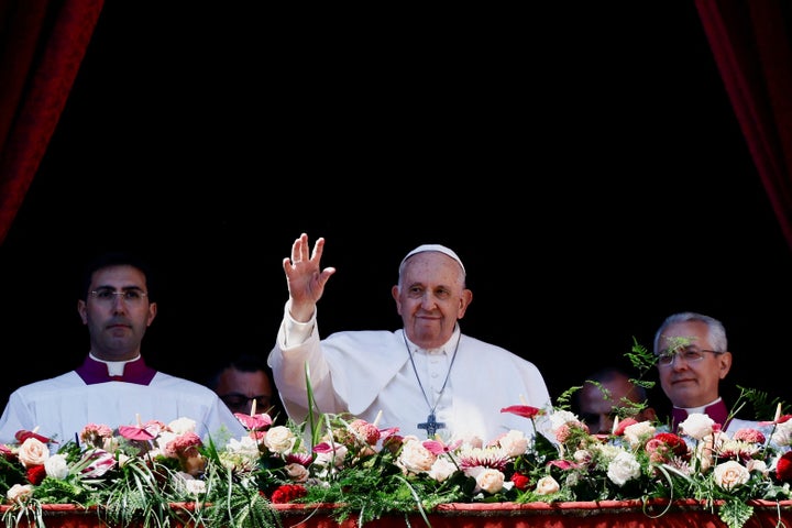 Pope Francis waves from a balcony at St. Peter's Square on Easter Sunday.