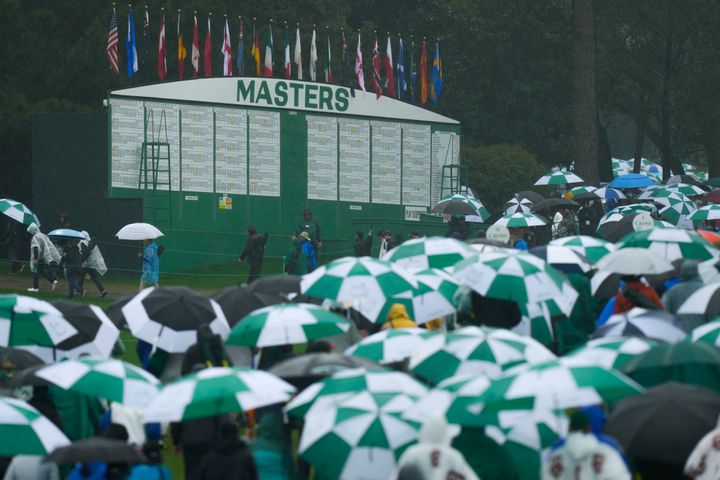 Patrons leave the course after play was suspended for the day Saturday due to the weather.