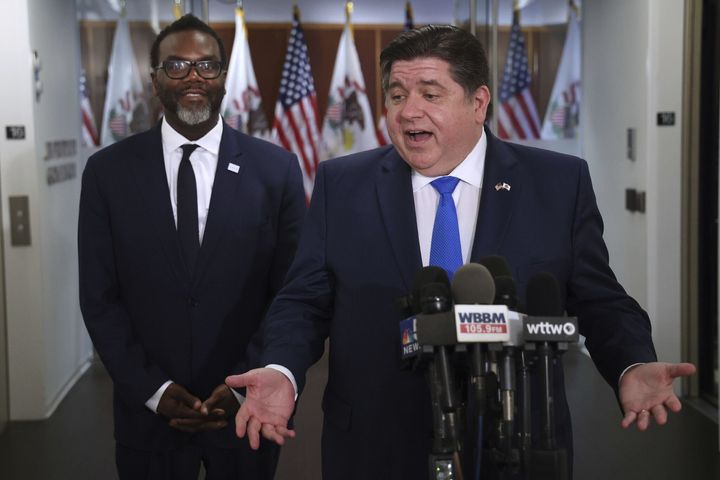 Johnson (left) and Democratic Illinois Gov. J.B. Pritzker speak to the media after meeting on Saturday. Pritzker, who was officially neutral in the race, had been criticized by Vallas.