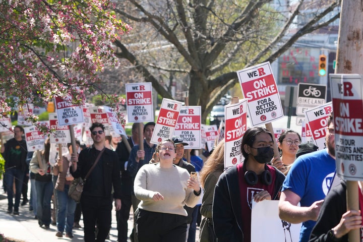 Strikers march in front of Rutgers' buildings in New Brunswick, N.J., Monday, April 10, 2023. Thousands of professors, part-time lecturers and graduate student workers at New Jersey's flagship university have gone on strike — the first such job action in the school's 257-year history. (AP Photo/Seth Wenig)