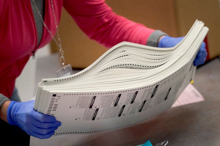 Problems with ballot printers that caused lines to back up at some Phoenix-area polling places last year were not caused by malicious actions but by changes to the paper, a retired Arizona Supreme Court justice concluded in a report released Monday, April 10, 2023. (AP Photo/Matt York, File)