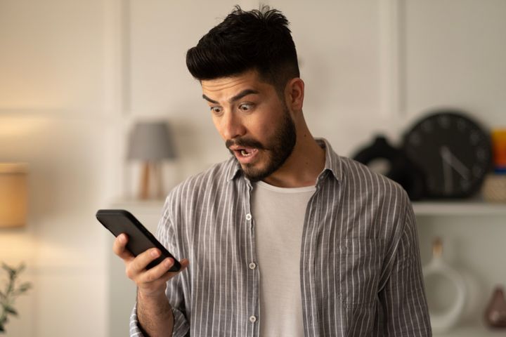 Man holding smartphone read unpleasant sms feels stressed