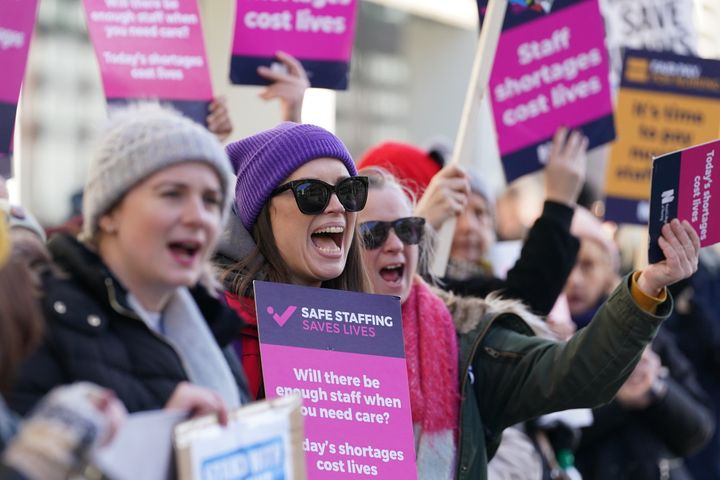 Workers on the picket line outside Royal Sussex County Hospital in Brighton during a strike by nurses and ambulance staff in February.