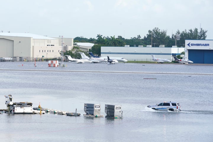 A truck drives on the flooded runway at Fort Lauderdale- Hollywood International Airport, on April 13, 2023, in Fort Lauderdale, Fla. 