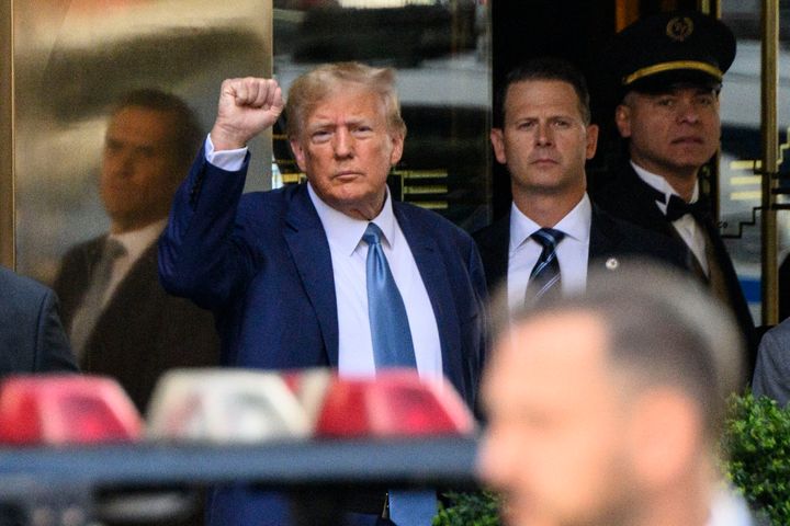 Donald Trump pumps his fist as he departs Trump Tower in New York on April 13, 2023. 