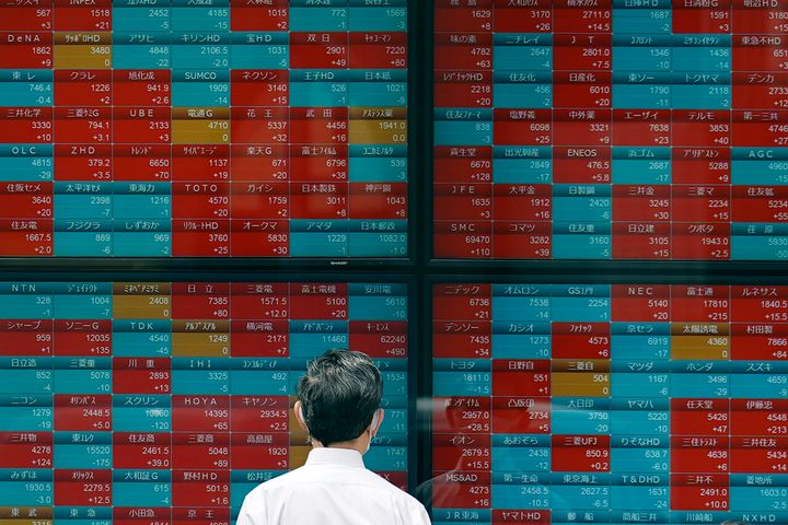 A person looks at an electronic stock board showing Japan's stock prices at a securities firm Friday, April 14, 2023, in Tokyo. (AP Photo/Eugene Hoshiko)