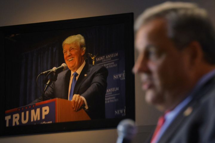 Former President Donald Trump hangs on the wall as former New Jersey Gov. Chris Christie speaks at the Institute of Politics at St. Anselm College in Manchester, New Hampshire, on March 27.