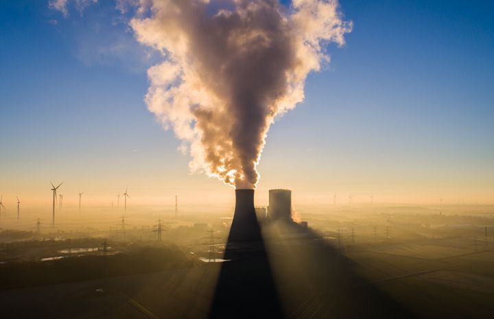 The sun rises behind Mehrum power plant in Hohenhamein, Germany, on Feb. 7. The coal-fired plant has been back on the grid as a "market returnee" since August 2022. An ordinance had allowed hard coal-fired power plants from the so-called grid reserve to be put back into operation in order to save natural gas.