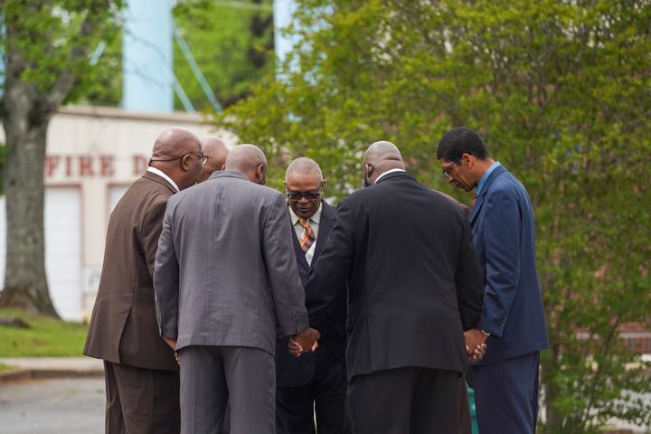 Pastors and community members hold a prayer event on Sunday near the Mahogany Masterpiece dance studio in Dadeville.