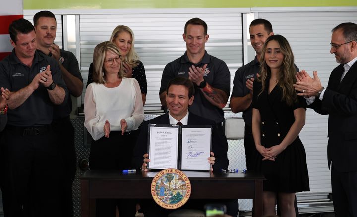 Florida Gov. Ron DeSantis signs a law on Feb. 27 that gives the state control of Disney World's Reedy Creek Improvement District, stripping the resort of its self-governing powers.