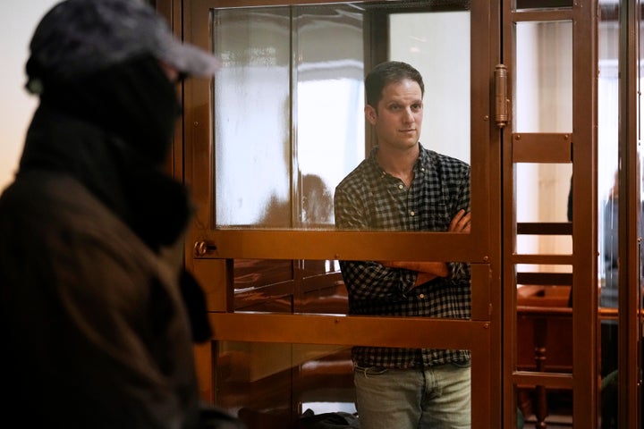 Wall Street Journal reporter Evan Gershkovich stands in a glass cage in a courtroom at the Moscow City Court, in Moscow, Russia, on April 18, 2023. 