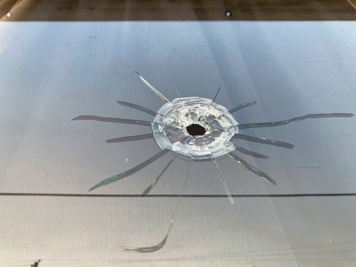 A bullet hole is visible in the glass transom over the door at the Mahogany Masterpiece dance studio in Dadeville, Ala., on April 16, 2023.