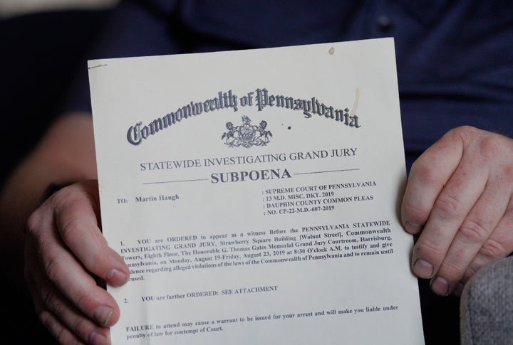 Martin Haugh, a former Jehovah's Witnesses elder and father of a sexual abuse victim, holds a subpoena, dated in 2019, ordering him to testify in front of a Pennsylvania grand jury, shown on Wednesday, April 12, 2023, in York Haven, Pa. The four-year grand jury investigation overseen by the attorney general's office has produced charges of child sexual abuse against nine men, all affiliated with the faith. (AP Photo/Jessie Wardarski)