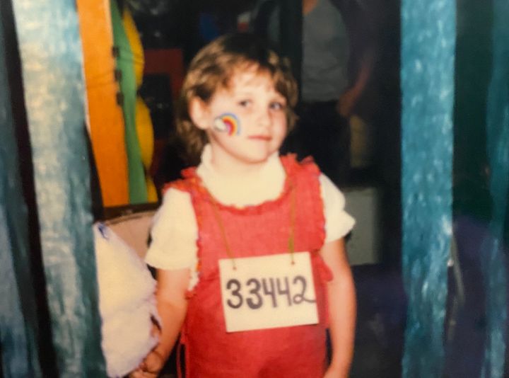 Jamie at the chronological age of 4 going on 5. "I'm 'in jail' at a church fundraising festival," she says. "Notice the rainbow face painting! This is how I see my 4-year-old part ('Lucy') in me today."