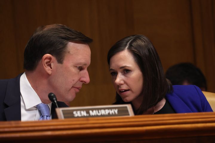 Sen. Chris Murphy (D-Conn.), left, talks to Sen. Katie Britt (R-Ala.) during a late March hearing on Capitol Hill. Murphy sees room for common ground on policies to combat loneliness.