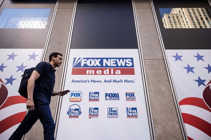 A person walks past the Fox News Headquarters in New York, Wednesday, April. 12, 2023. (AP Photo/Yuki Iwamura)