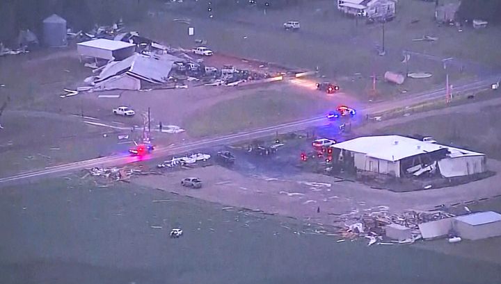 In this image taken from video, emergency vehicles make their way past damaged buildings after a tornado swept through the area, in Cole, Okla., Wednesday night, April 19, 2023. Central Oklahoma saw multiple tornadoes, including one that raced through the communities of Cole and Shawnee Wednesday night. 