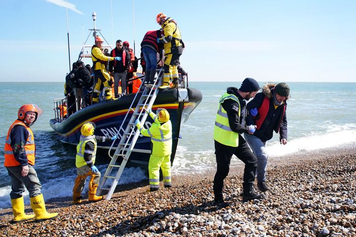 A group of people thought to be migrants arrive on the beach in Dungeness, Kent.