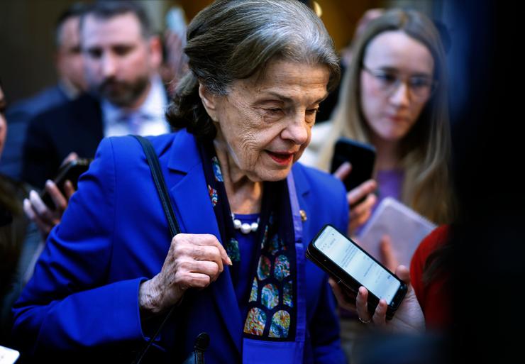 Sen. Dianne Feinstein (D-Calif.) is surrounded by reporters as she heads to the Senate Chamber for a vote in the U.S. Capitol on February 14, 2023, in Washington, D.C. Feinstein announced Tuesday that she will not seek re-election in 2024.