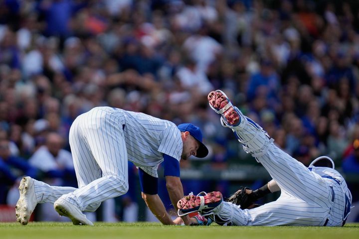 Chicago Cubs catcher Yan Gomes collides Friday with starting pitcher Drew Smyly, preventing the throw to first base and ending Smyly's chance at a perfect game during the eighth inning against the Los Angeles Dodgers in Chicago.